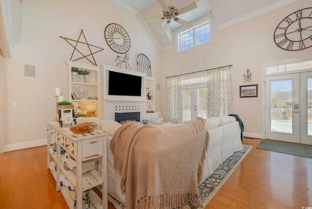 living room featuring french doors, plenty of natural light, and light hardwood / wood-style floors