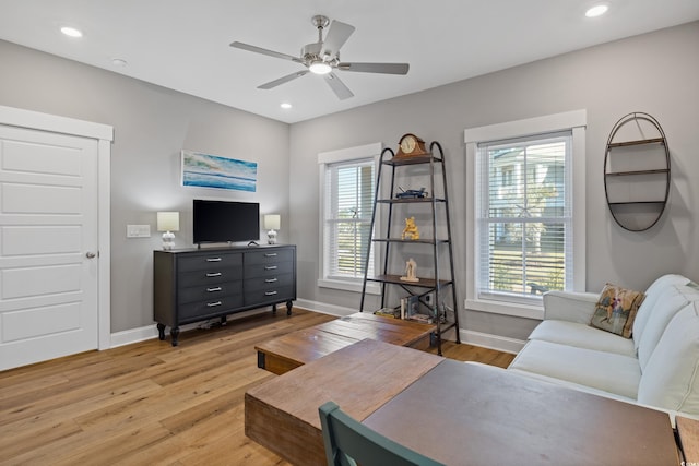 living area featuring light wood-style floors, ceiling fan, baseboards, and recessed lighting