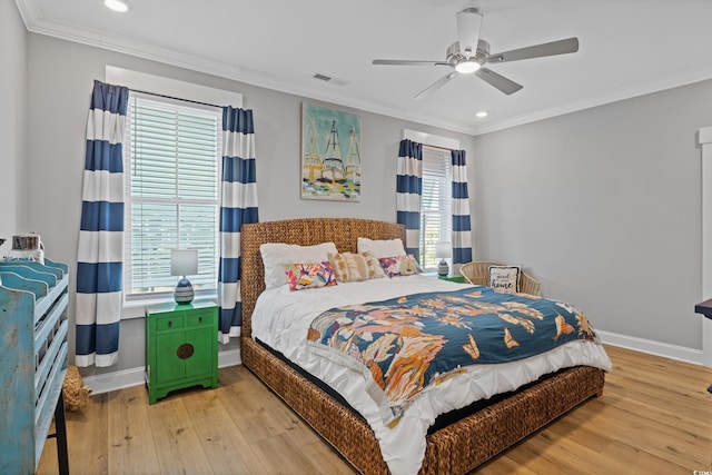 bedroom with multiple windows, visible vents, and crown molding