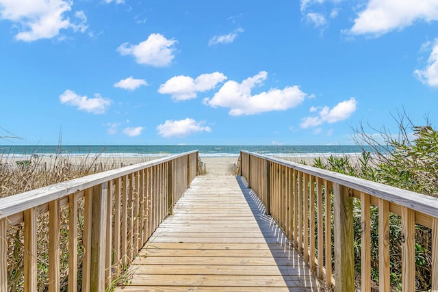 surrounding community featuring a view of the beach and a water view