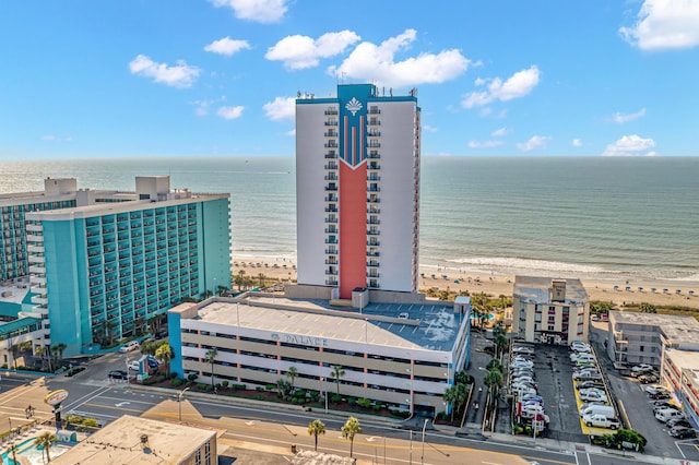 drone / aerial view featuring a water view and a view of the beach