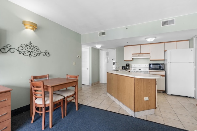 kitchen with white cabinetry, white appliances, kitchen peninsula, and light tile patterned floors