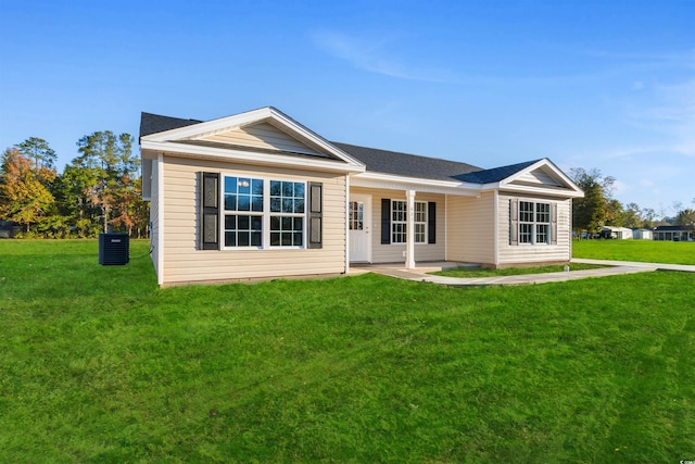 ranch-style home with central AC unit and a front yard