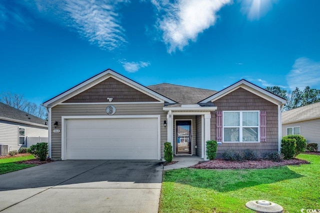 view of front of house featuring central AC unit, a garage, and a front yard