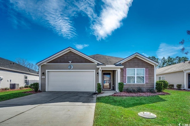 view of front of house featuring a garage, central AC, and a front yard