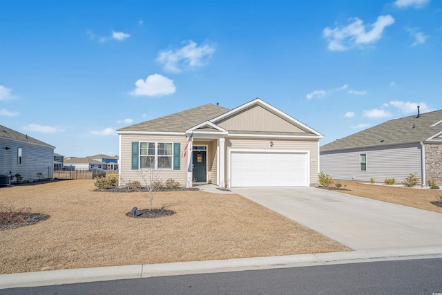 view of front of house featuring an attached garage, driveway, and fence