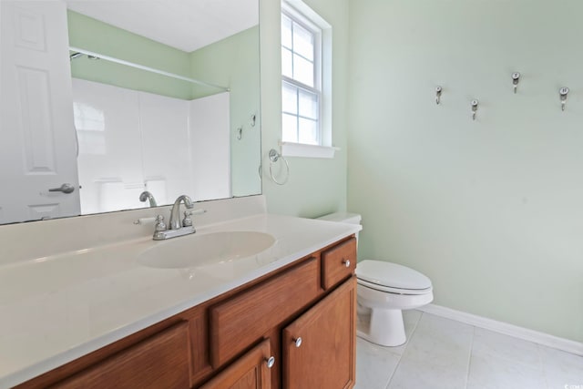 bathroom featuring vanity, tile patterned flooring, a shower, and toilet