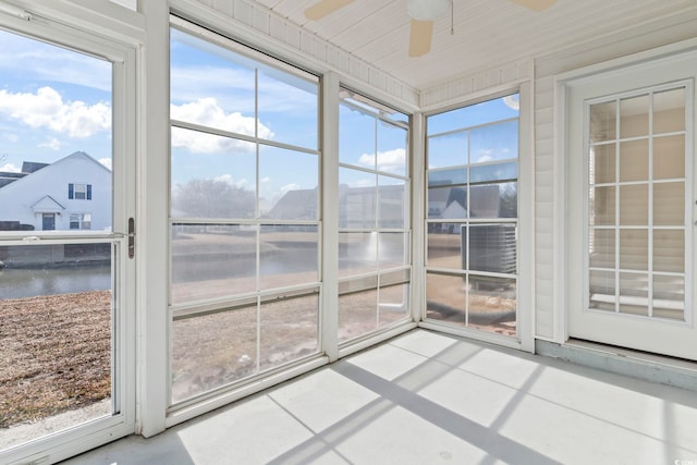 unfurnished sunroom with ceiling fan