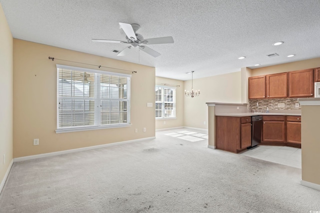 kitchen with pendant lighting, tasteful backsplash, a textured ceiling, light carpet, and ceiling fan with notable chandelier