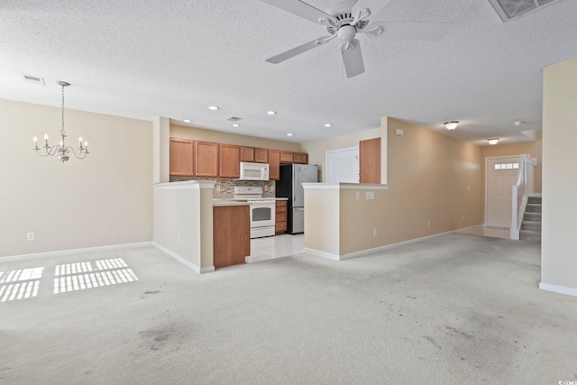 kitchen with ceiling fan with notable chandelier, decorative backsplash, hanging light fixtures, light carpet, and white appliances