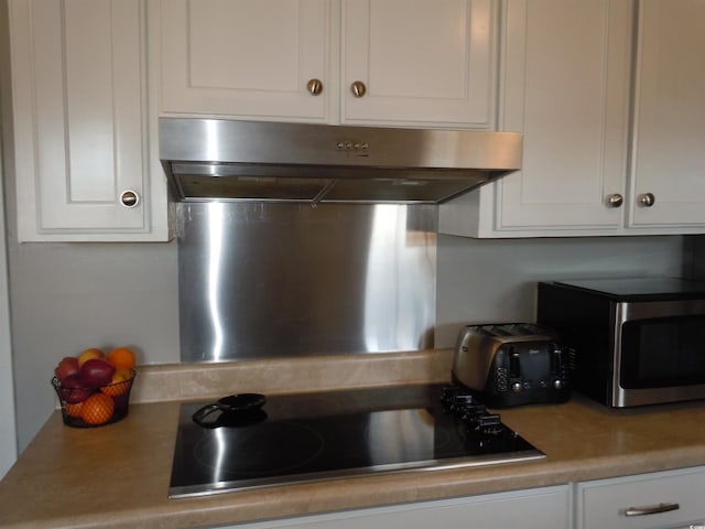 kitchen featuring black electric cooktop and white cabinets