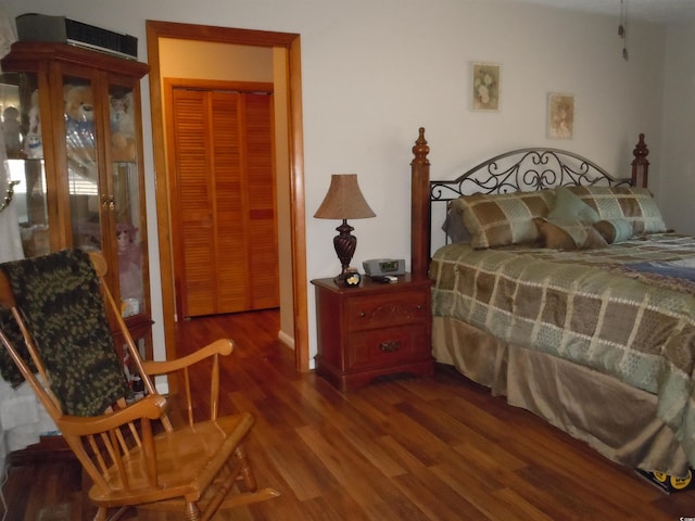 bedroom with dark wood-type flooring