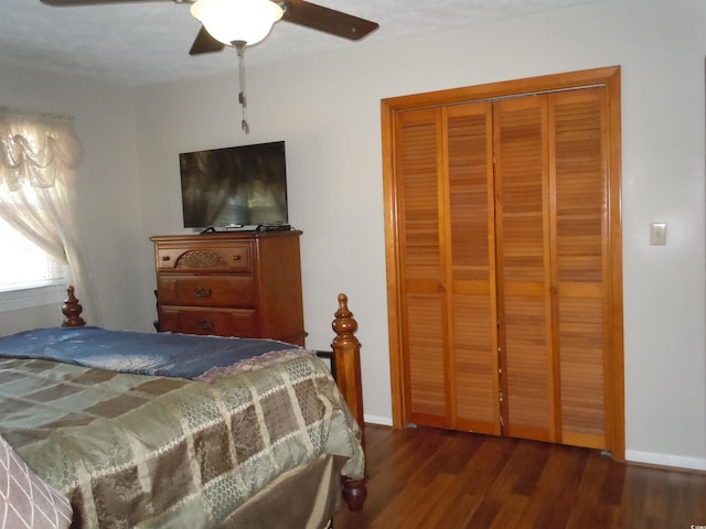 bedroom with ceiling fan, dark hardwood / wood-style flooring, and a closet