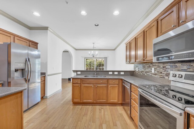 502 Hay Hill Ln Unit B, Myrtle Beach, SC 29579 - kitchen with sink, light hardwood / wood-style flooring, stainless steel appliances, decorative light fixtures, and kitchen peninsula