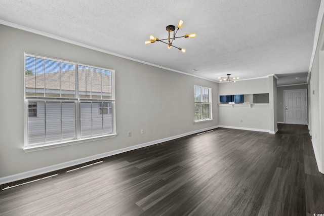 unfurnished living room with ornamental molding, dark hardwood / wood-style floors, and a chandelier