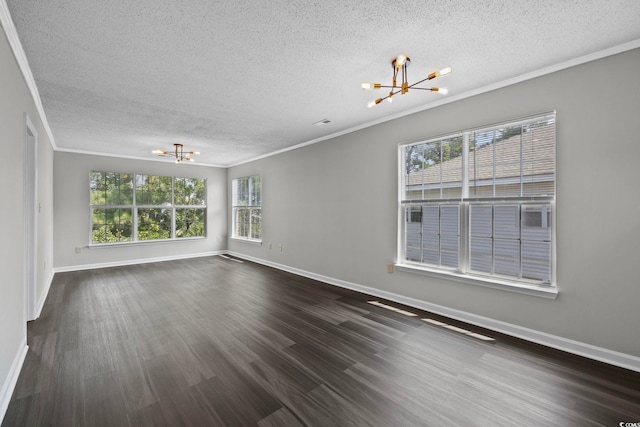 unfurnished room featuring dark hardwood / wood-style flooring, ornamental molding, a textured ceiling, and a chandelier