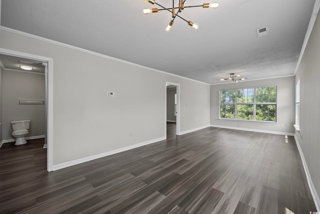 unfurnished living room featuring crown molding, dark hardwood / wood-style floors, and a chandelier