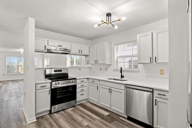 kitchen featuring stainless steel appliances, sink, and white cabinets