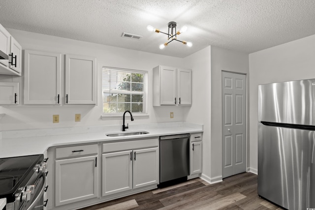 kitchen featuring white cabinetry, stainless steel appliances, dark hardwood / wood-style flooring, and sink