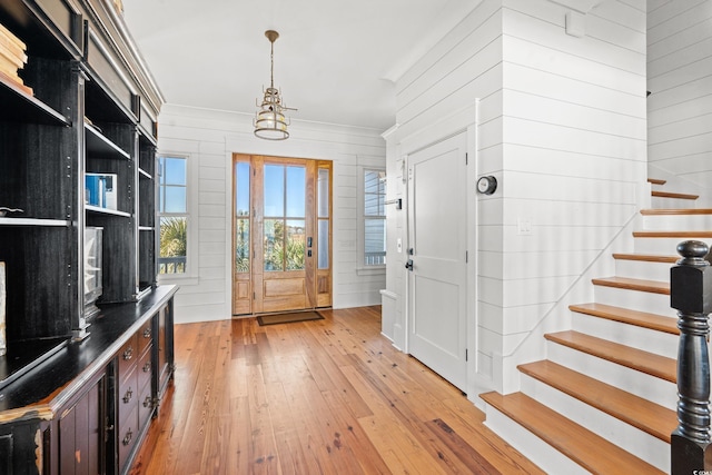 interior space featuring light hardwood / wood-style flooring and wood walls