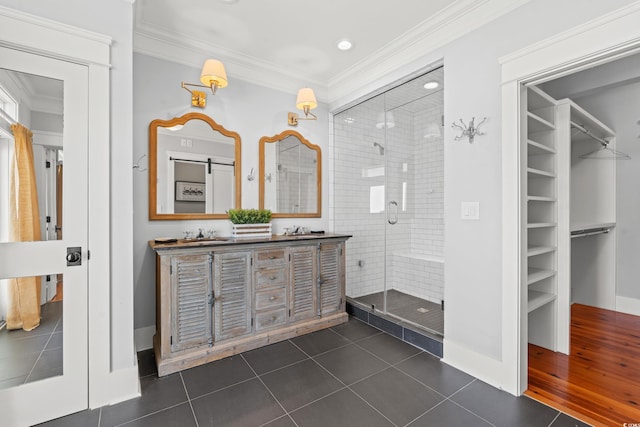 bathroom featuring crown molding, vanity, tile patterned flooring, and a shower with door