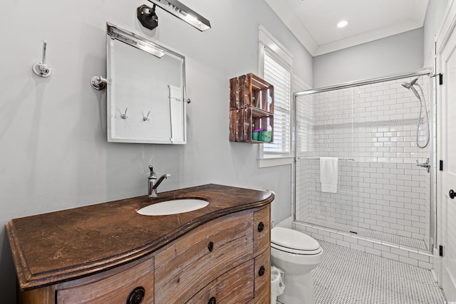 bathroom with vanity, ornamental molding, an enclosed shower, and toilet