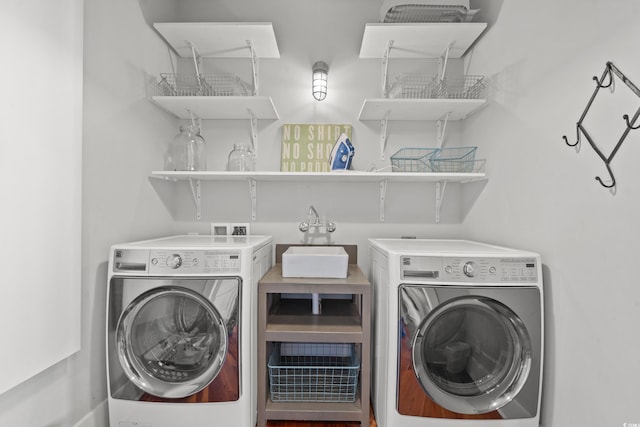 clothes washing area featuring separate washer and dryer and sink