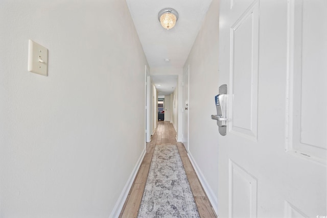 corridor with light hardwood / wood-style floors