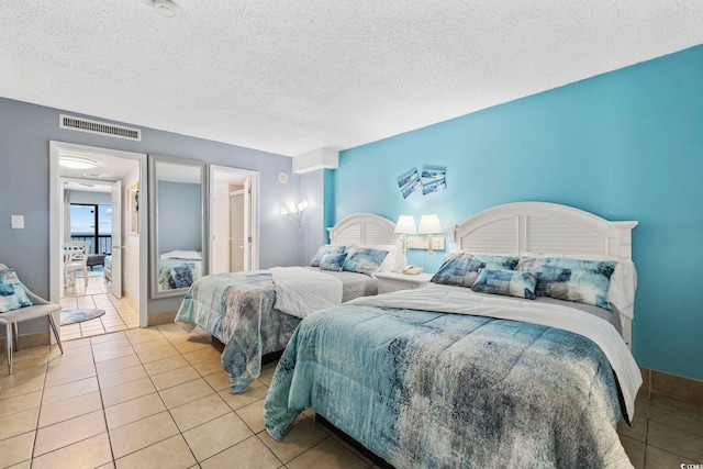 tiled bedroom with a textured ceiling