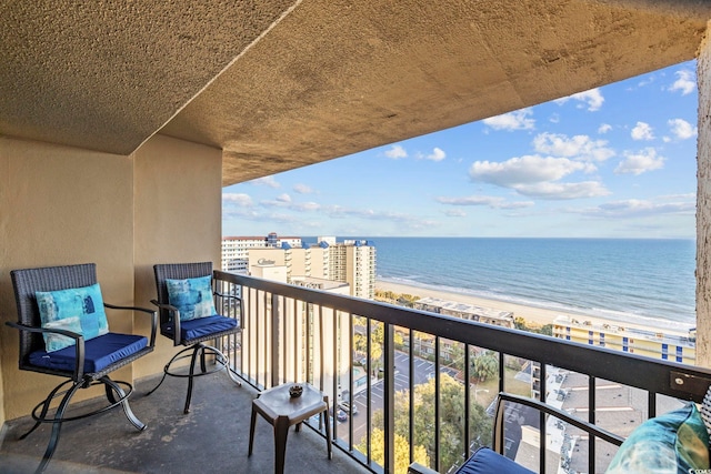 balcony with a beach view and a water view