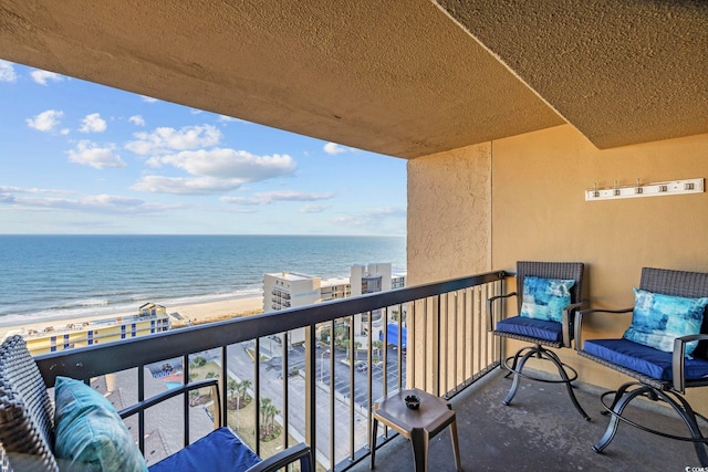 balcony with a view of the beach and a water view