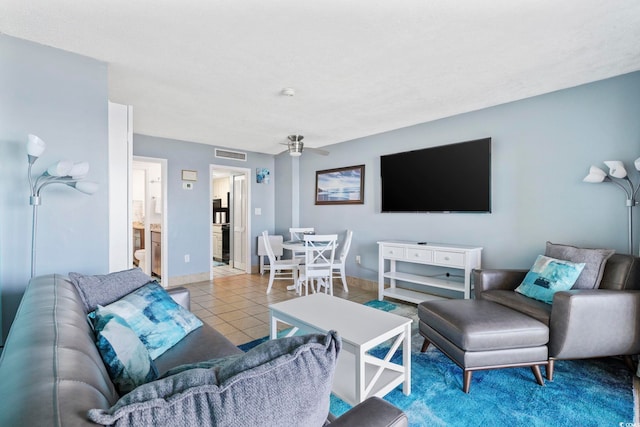 tiled living room with ceiling fan