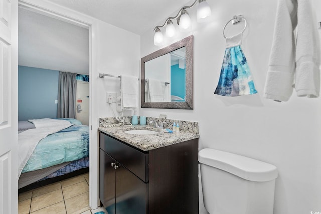 bathroom featuring tile patterned flooring, vanity, and toilet