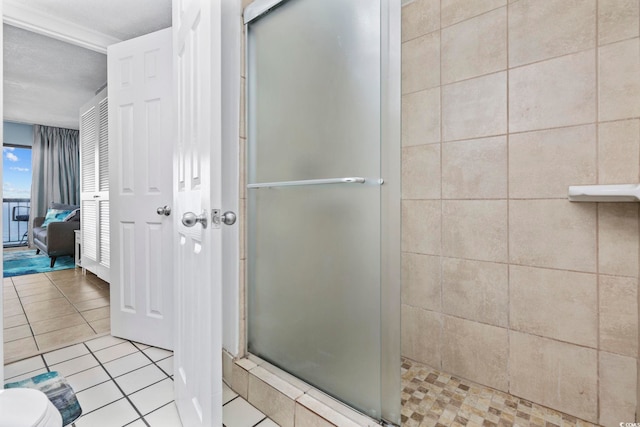 bathroom featuring tile patterned flooring and a shower with door