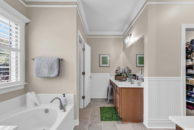 bathroom with crown molding, vanity, tile patterned flooring, and a bathtub