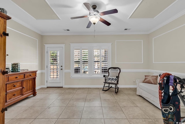 living area featuring light tile patterned floors, crown molding, and ceiling fan