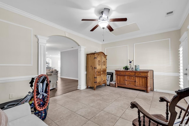 interior space featuring ornate columns, crown molding, light tile patterned flooring, and ceiling fan