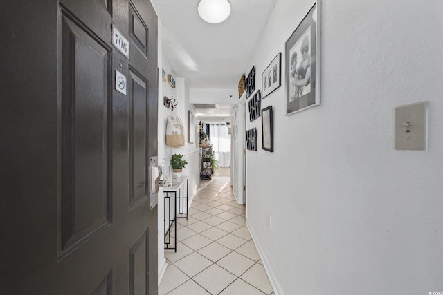 hallway featuring light tile patterned flooring