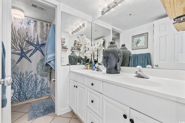 bathroom with vanity, tile patterned floors, and walk in shower