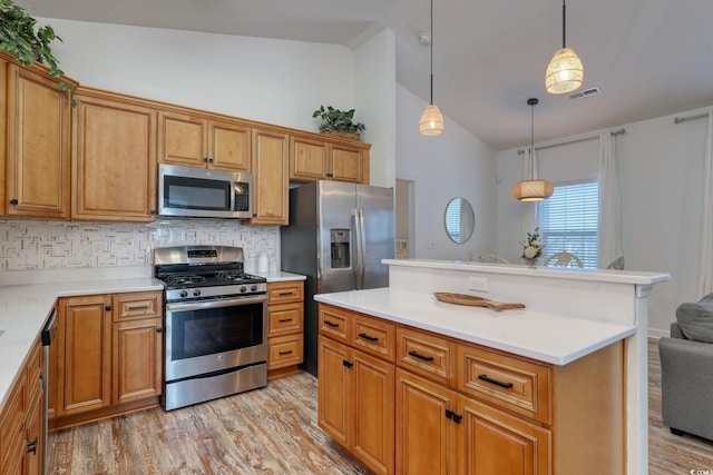 kitchen with appliances with stainless steel finishes, tasteful backsplash, light hardwood / wood-style floors, decorative light fixtures, and vaulted ceiling