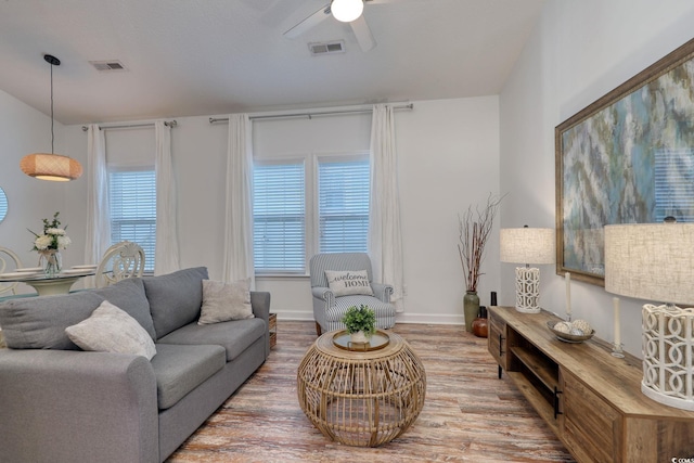 living room featuring hardwood / wood-style flooring and ceiling fan