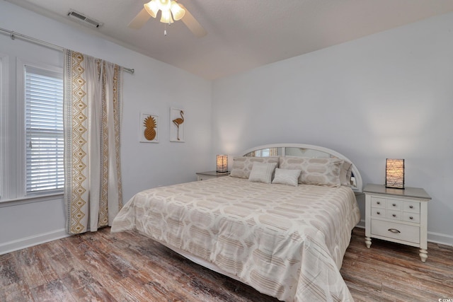 bedroom with ceiling fan and dark hardwood / wood-style floors