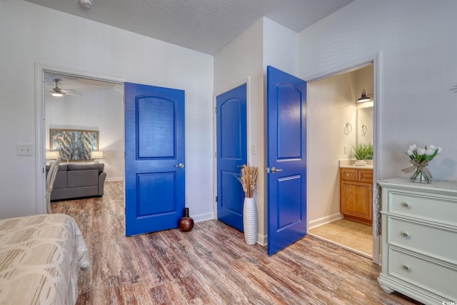 bedroom featuring hardwood / wood-style floors and a textured ceiling