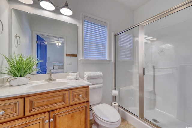 bathroom with walk in shower, vanity, and toilet