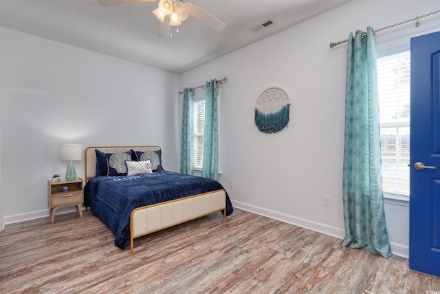 bedroom featuring light hardwood / wood-style floors and ceiling fan