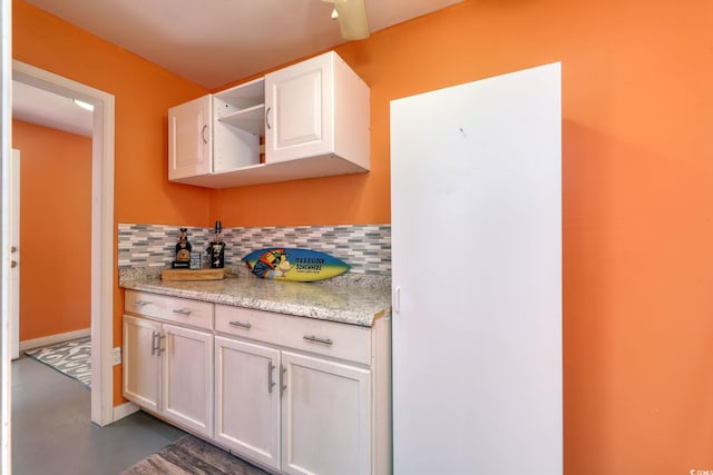 kitchen with white cabinetry and tasteful backsplash