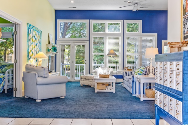 sunroom / solarium featuring ceiling fan and a mail area