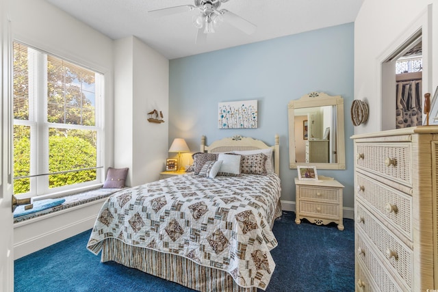 bedroom featuring dark colored carpet and ceiling fan