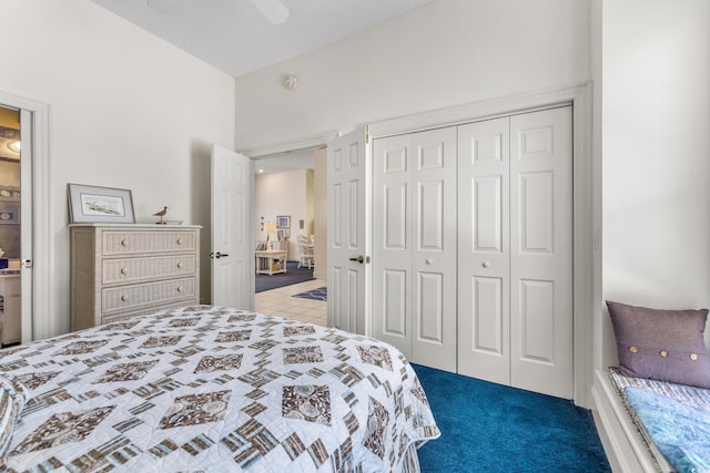 bedroom with ceiling fan, light colored carpet, and a closet