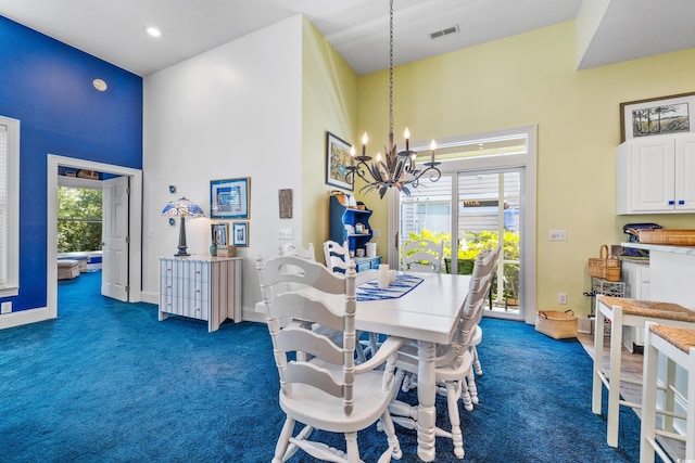 dining space featuring an inviting chandelier, dark carpet, and a high ceiling